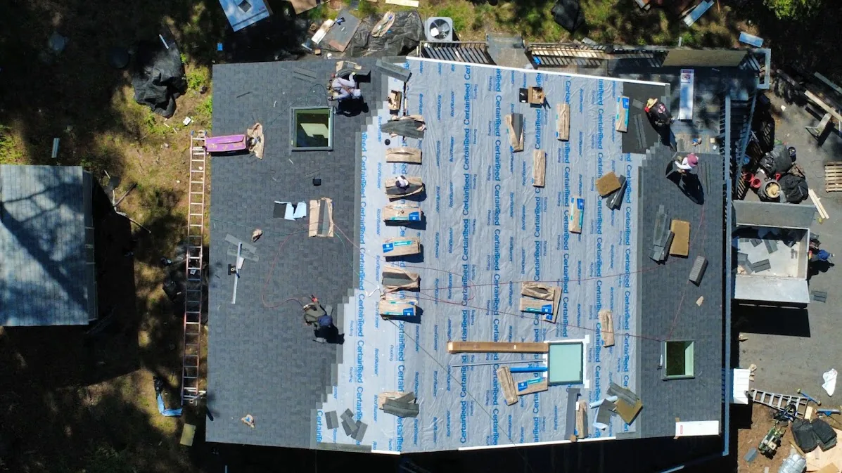 CertainTeed underlayment covering the roof deck with new architectural shingles going on course by course